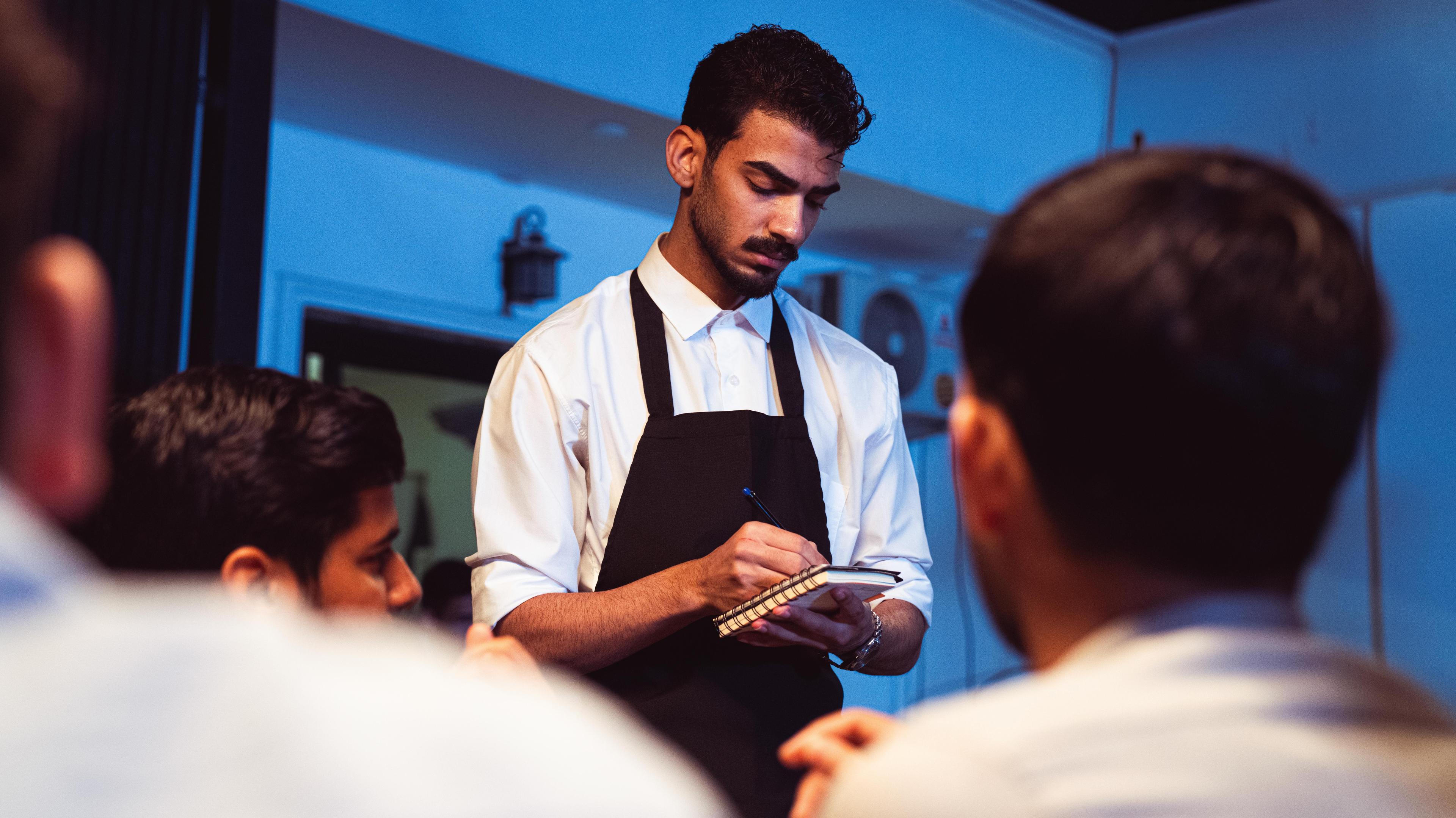 A server taking guest orders