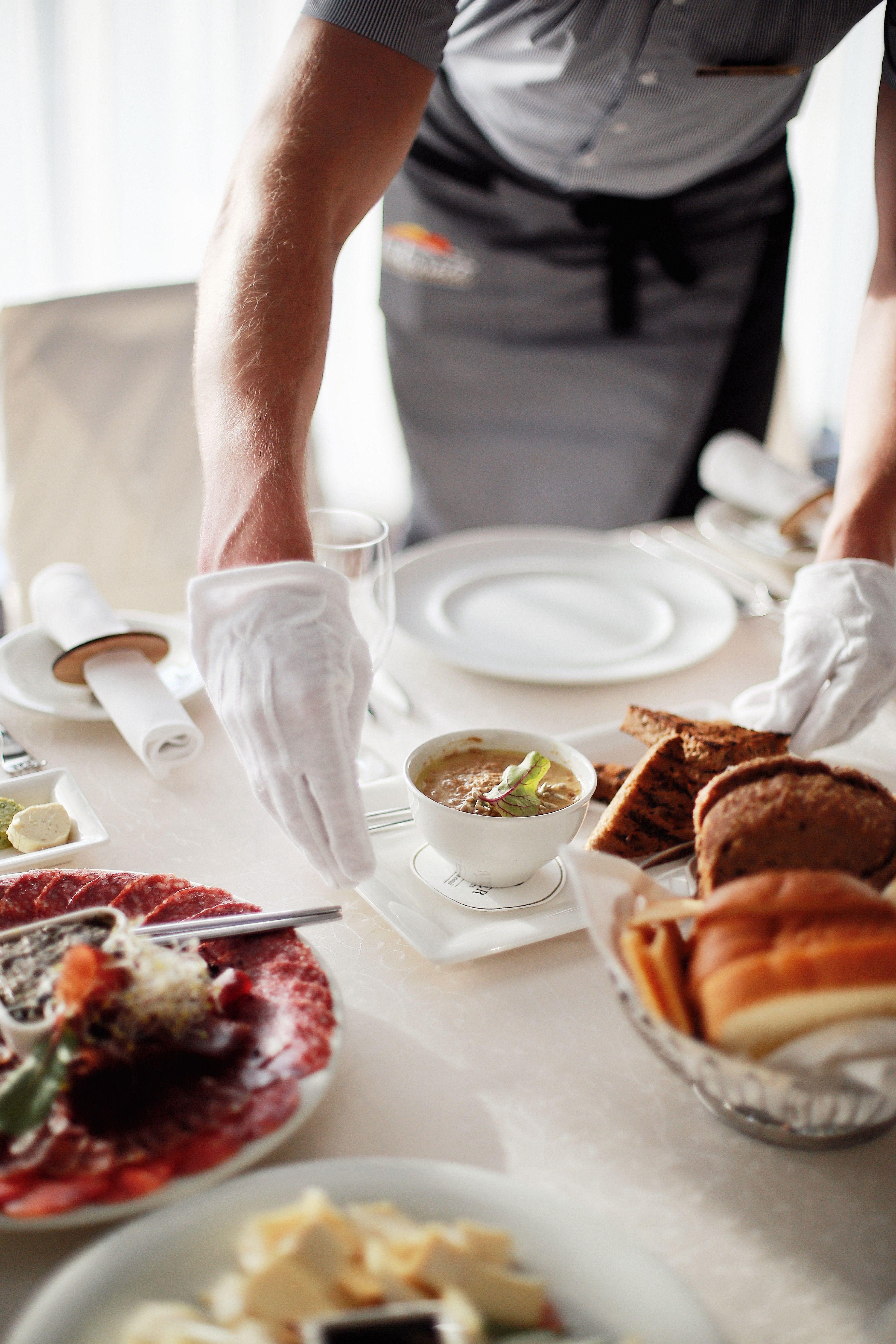 A server attending to guests at the table